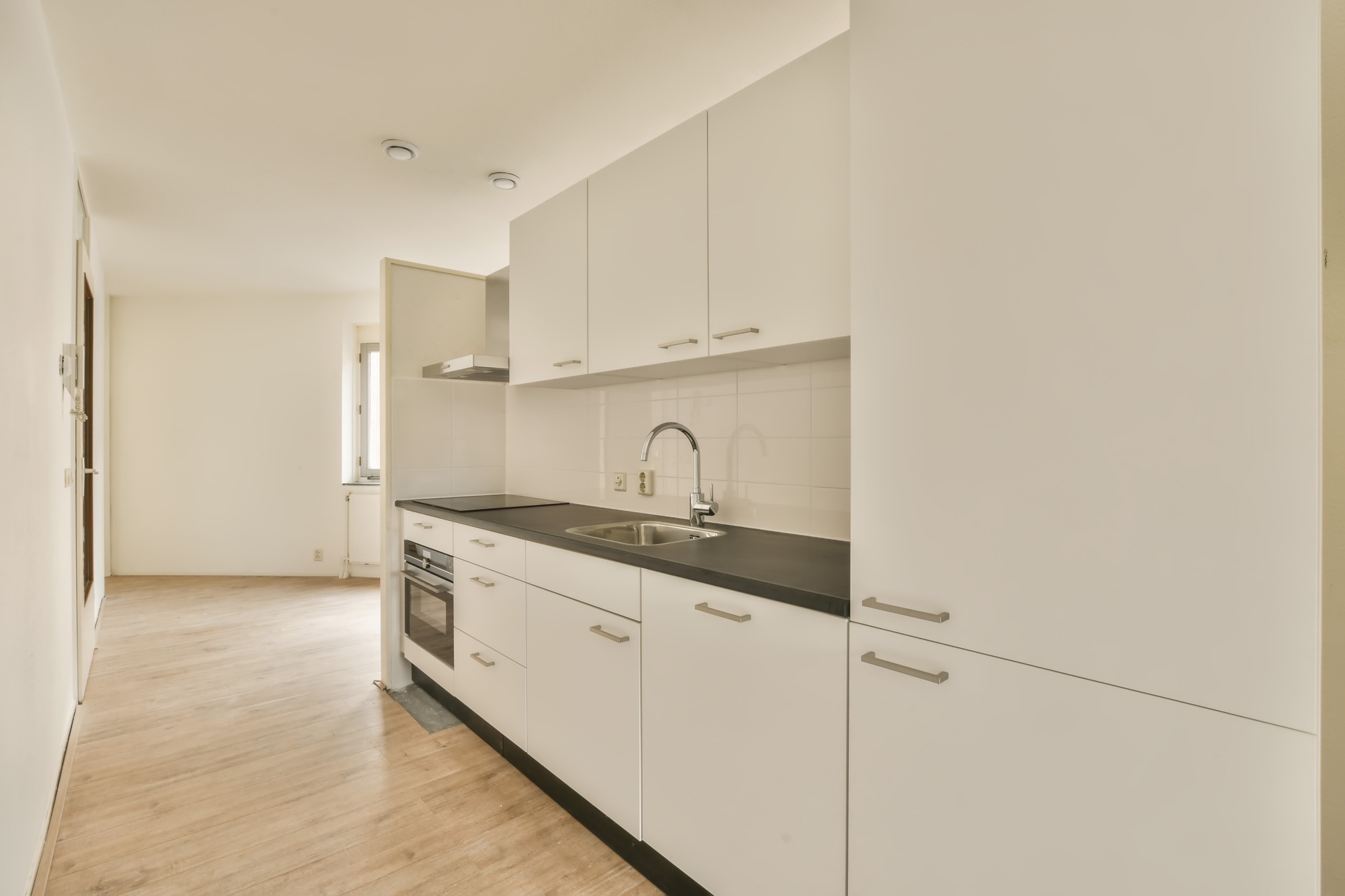 a kitchen with white cabinets and a sink